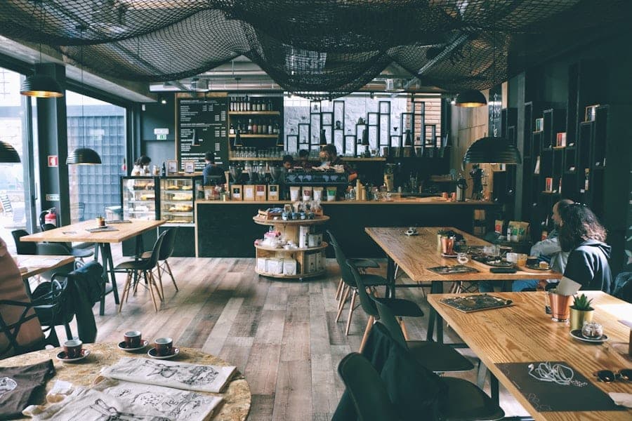 Cafe dining room with wooden tables in front of the coffee counter