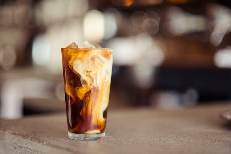 Iced coffee with cream swirling through it
